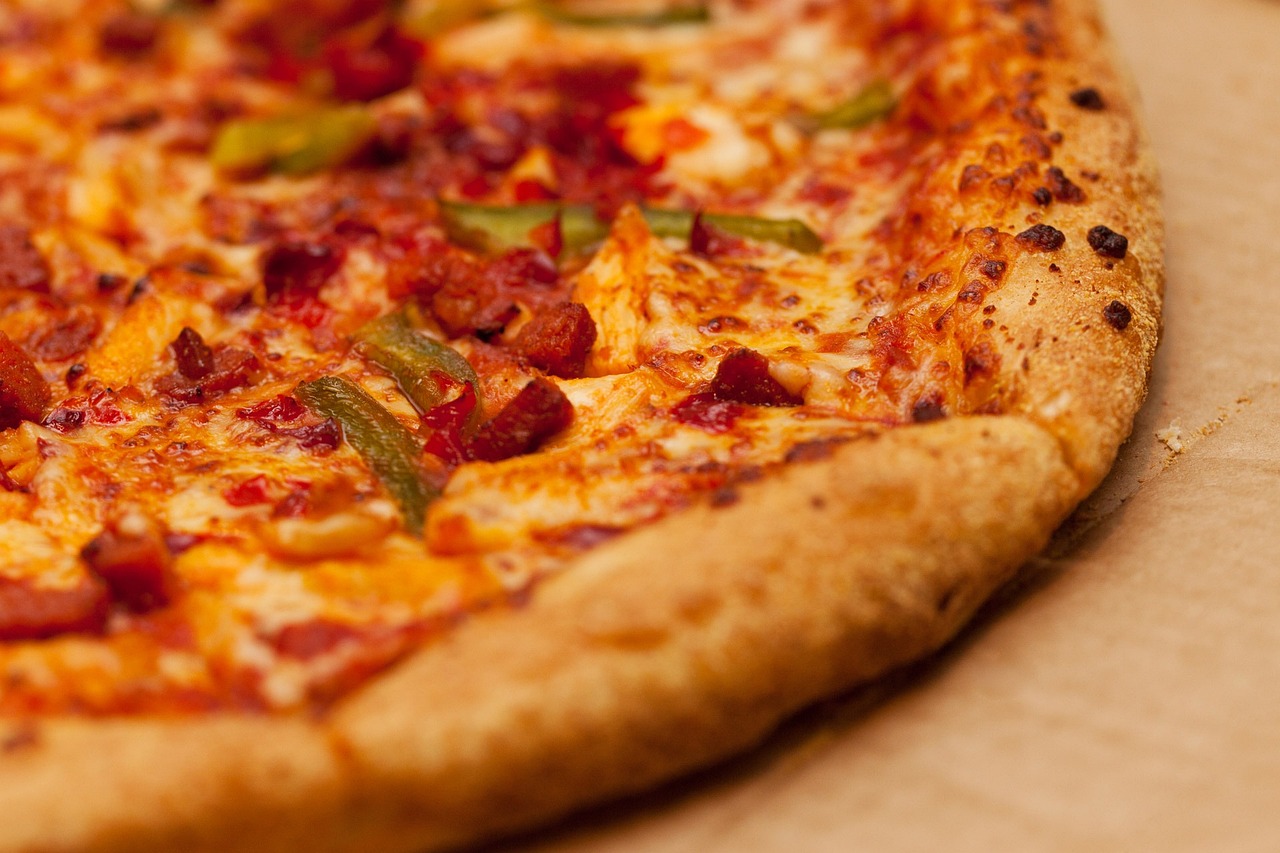 A close-up shot of a pizza on a wooden table
