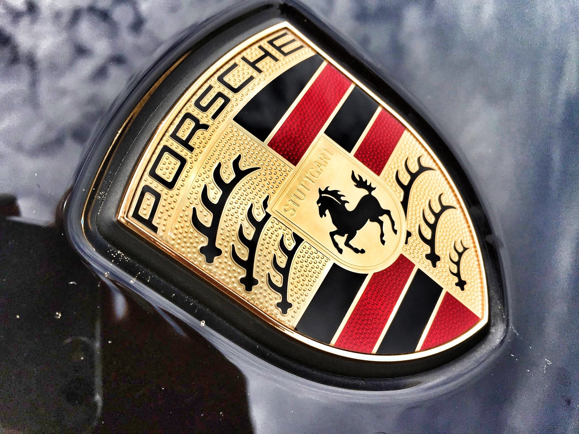 Close-up of the Porsche emblem on the front of a vehicle